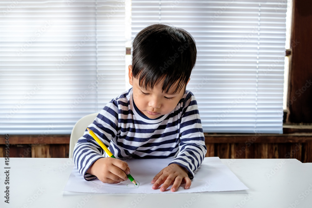 Asian Little child drawing on the paper Asian Little child drawing on the paper