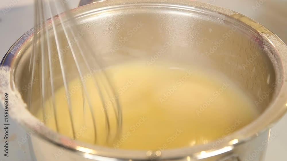 Stirring french onion soup in a saucepan Stirring french onion soup in a saucepan