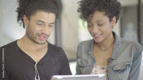 Couple using digital tablet together photo