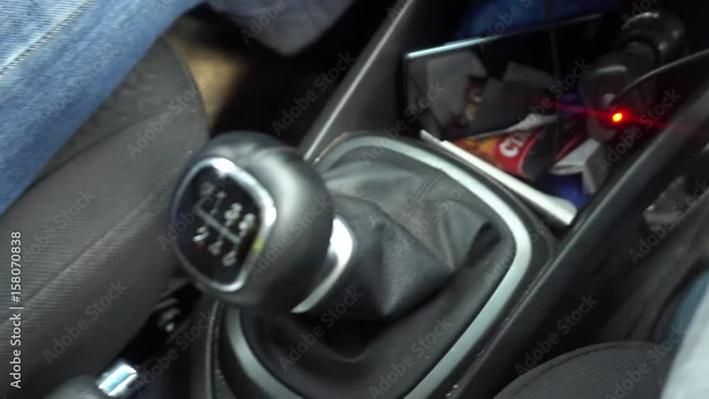 switching manual gearbox, the man's hand shifts gears in the car. switching manual gearbox, the man's hand shifts gears in the car.