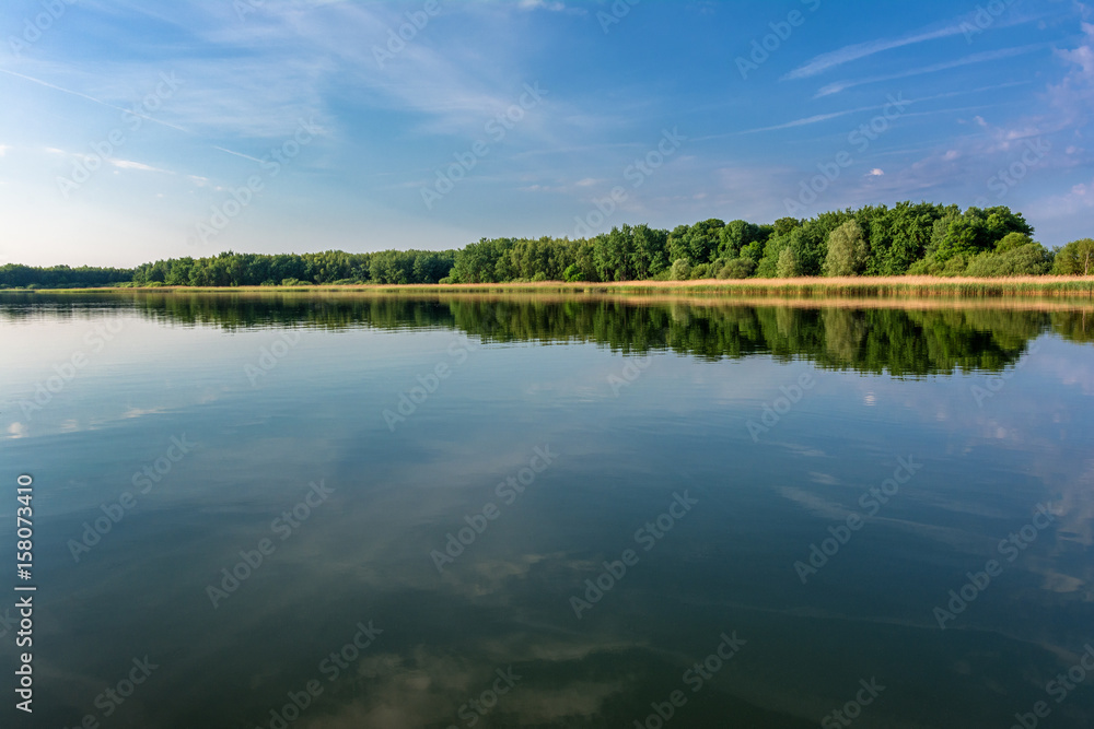 French countryside. Lake Lac de Madine in the Parc Naturel Regional de Lorraine in the early morning after sunrise.