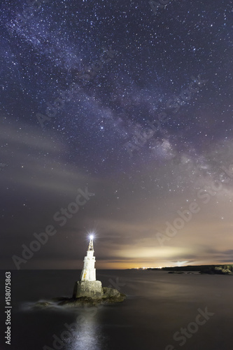Milky way over the old lighthouse in the port of Ahtopol, Black Sea, Bulgaria