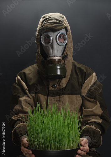 the photo of man in gas mask on grey background