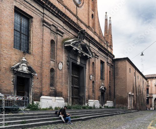 Couple sitting on the steps of the church of San Paolo, in the square of Alberto schiatti photo