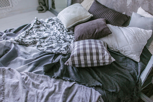 bedroom interior, gray pillows and blankets on bed, bedding