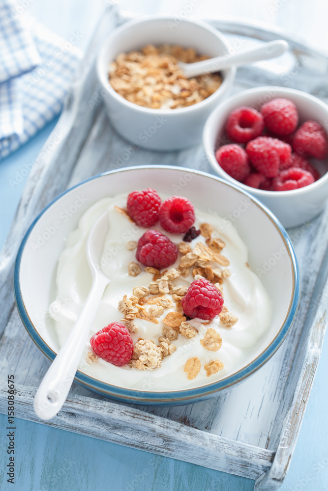 yogurt with granola and raspberry for healthy breakfast
