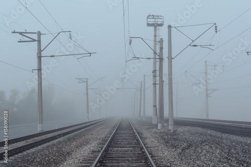 railroad goes to horizon in fog © penyushkin