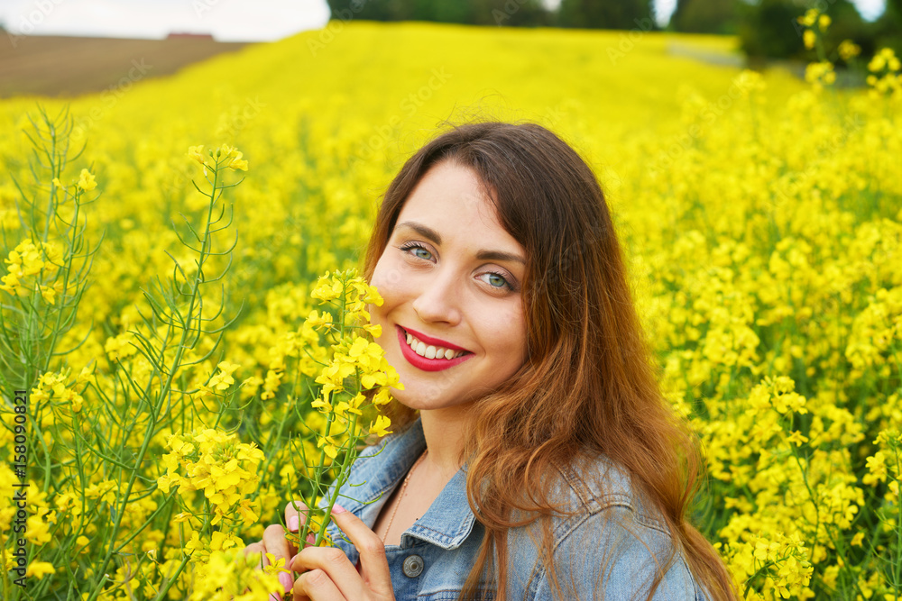 A young caucasian woman in rapeseed field A young caucasian woman in rapeseed field