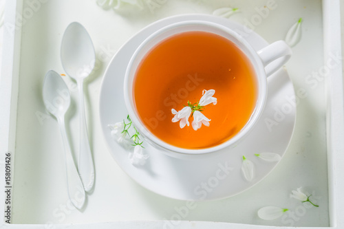 Fresh tea with honey in sunny summer day