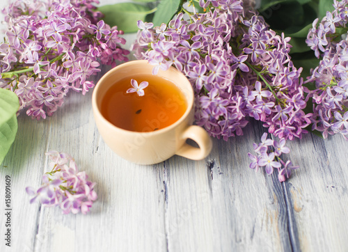 Morning on table with cup of tea and flowers