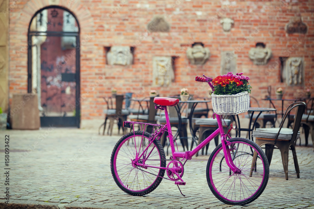 pink bike standing on place
