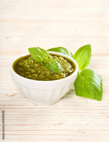 green pesto on a wooden background