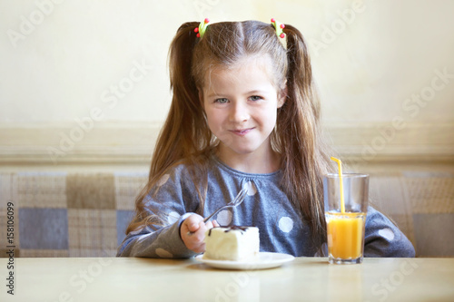 Cute little girl with cake ...