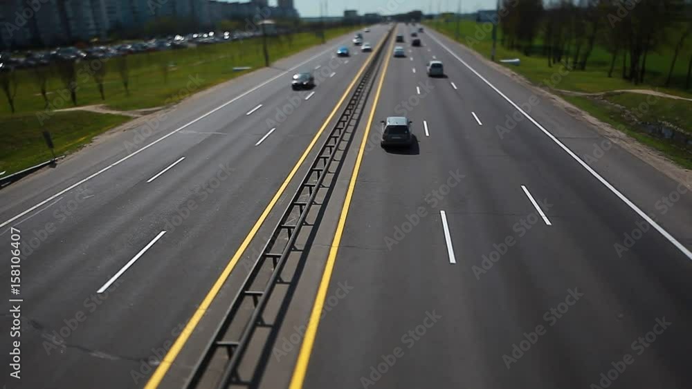 Cars go by day on the highway view from above. Cracked asphalt road. Cars go by day on the highway view from above. Cracked asphalt road.