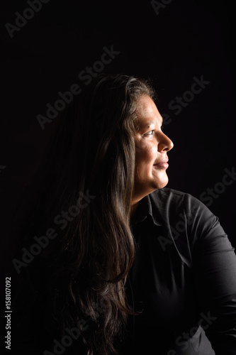 Portrait of a latin woman on black background