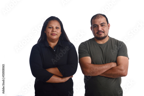 portrait of a latinamerica couple with arms crossed on white