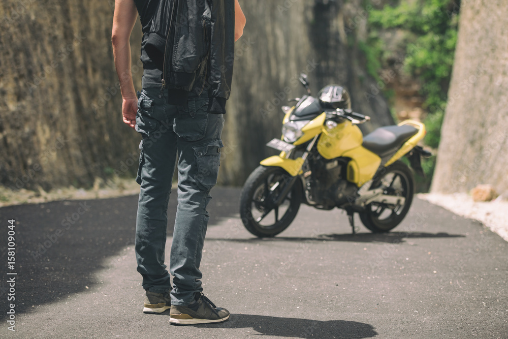 Modern handsome man posing with his motorbike. Modern handsome man posing with his motorbike.