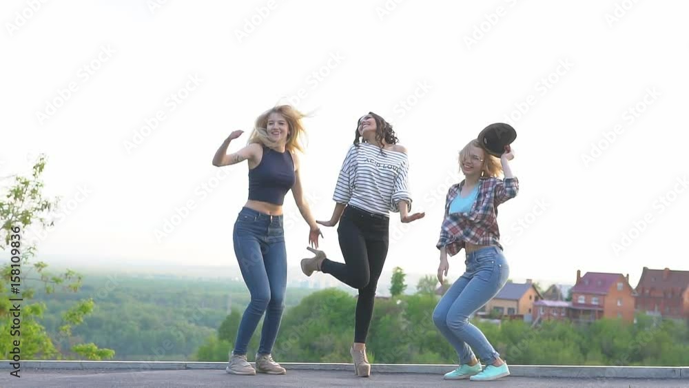 girlfriends having fun and jumping with joy. best friends spend time together outdoors. slow motion girlfriends having fun and jumping with joy. best friends spend time together outdoors. slow motion