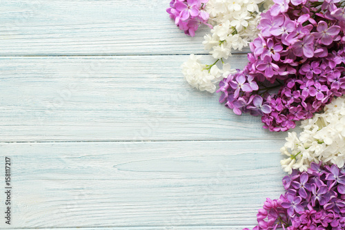 Beautiful lilac flowers on wooden background © Africa Studio