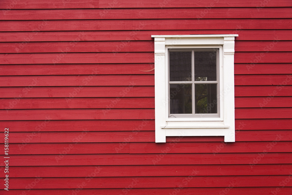 Detail of red wooden house with window