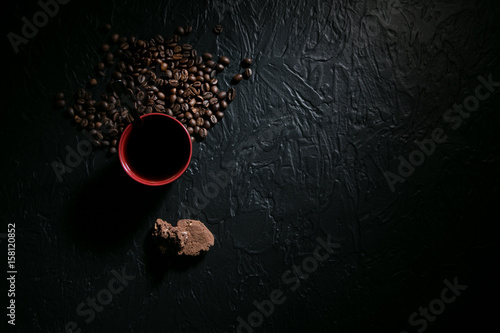 coffee cup and coffee beans on wooden table with cookies