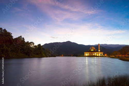 Beautiful view of Darul Quran mosque with reflections during sunrise in Selangor, Malaysia.