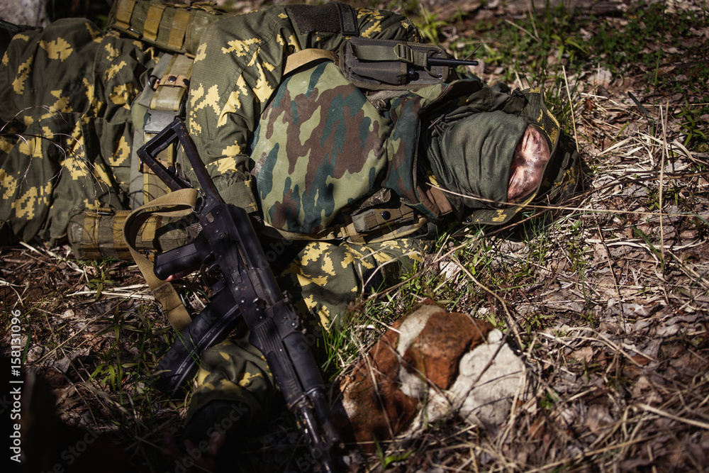 Soldier lies on the ground
