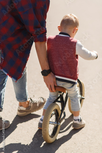 Dad teaches son to ride