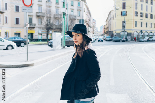 young woman outdoor walking looking away pensive - attitude, confidence, serious concept