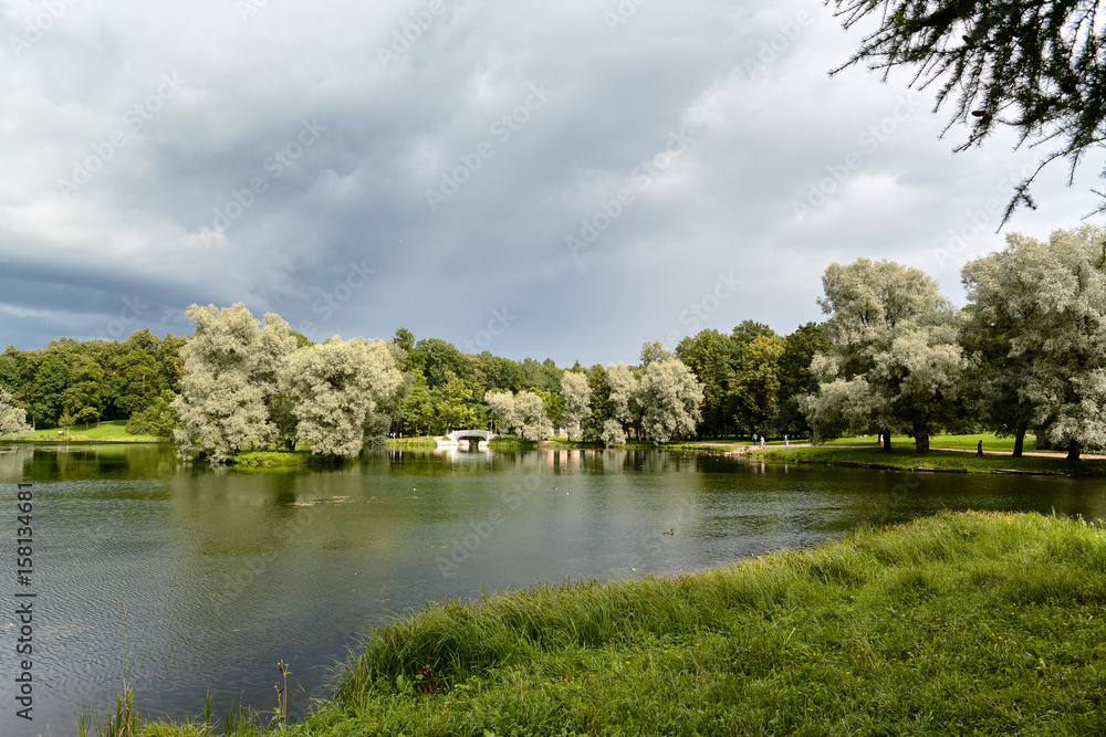 A picturesque view in Gatchina Palace Park on the beautiful nature and architecture. Summer landscape in the Gatchina, St. Petersburg, Russia. A picturesque view in Gatchina Palace Park on the beautiful nature and architecture. Summer landscape in the Gatchina, St. Petersburg, Russia.