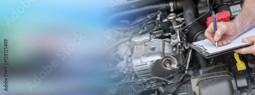 Plakat Car mechanic checking a car engine