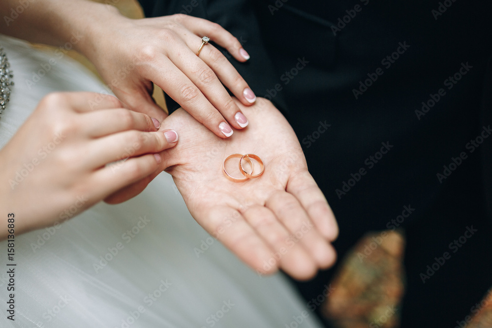 Golden wedding rings in groom's palm