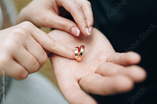 Golden wedding rings in groom's palm