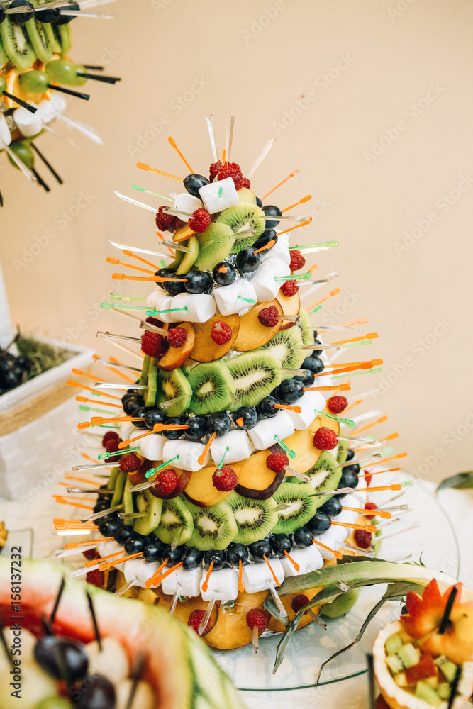 Pyramid of kiwi, marshmallow, strawberry and other fruits
