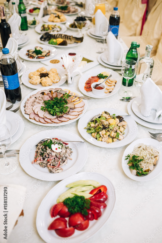 Plates with sliced meat and vegetables