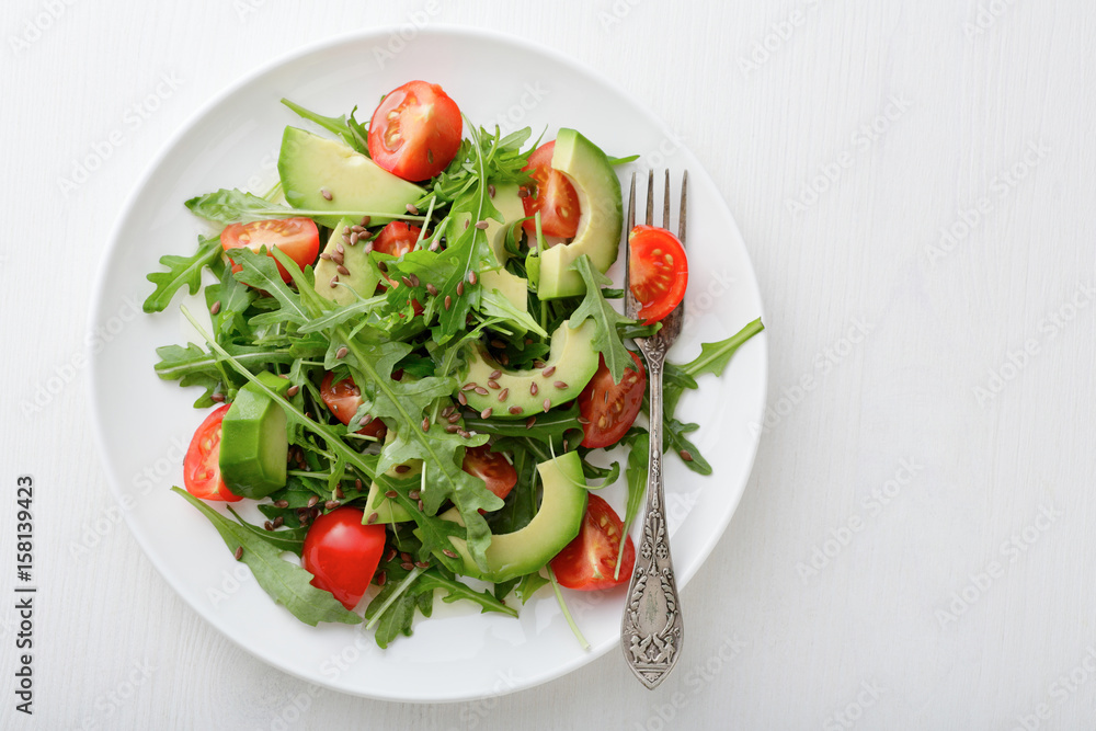 Light Salad with avocado, cherry tomatoes and arugula Light Salad with avocado, cherry tomatoes and arugula