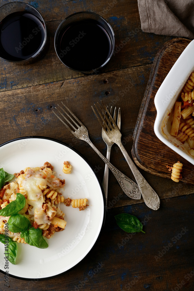 Pasta with Bolognese sauce and wine on old wooden table Pasta with Bolognese sauce and wine on old wooden table