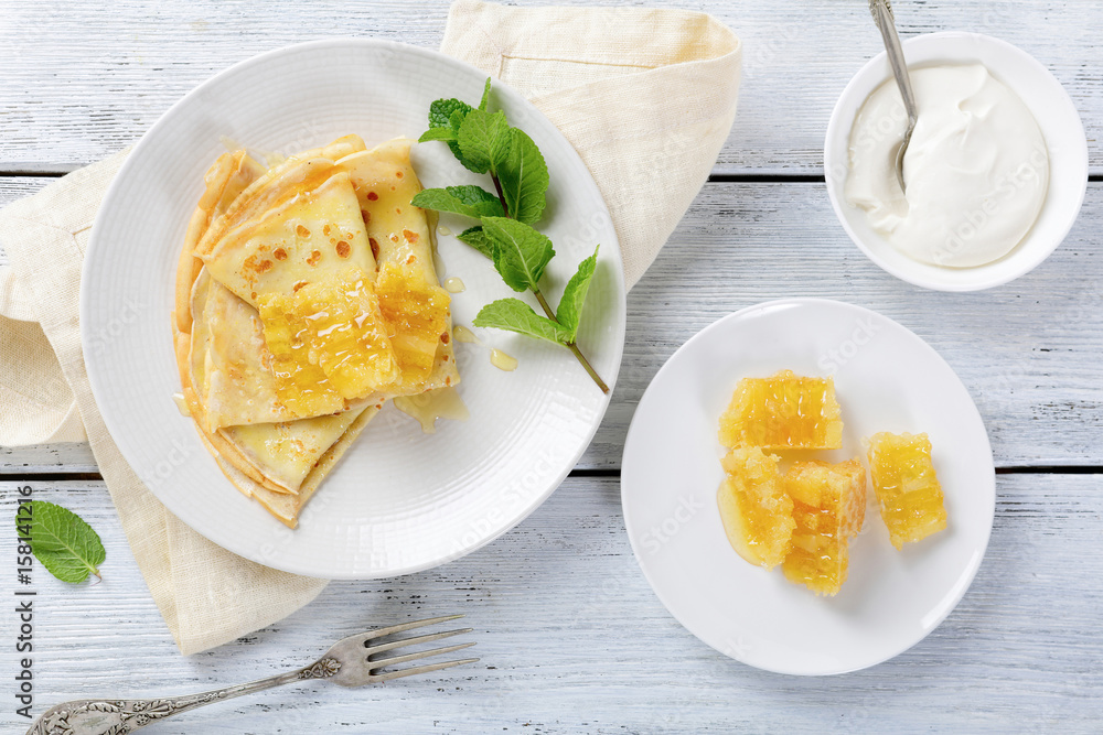 Sweet pancakes with honey on a plate Sweet pancakes with honey on a plate
