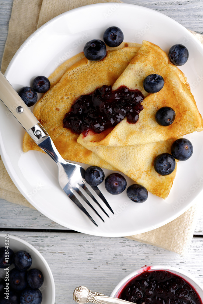 Crepes with jam and forest berries on a plate Crepes with jam and forest berries on a plate