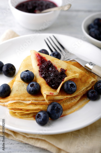 Crepes with jam on a white plate