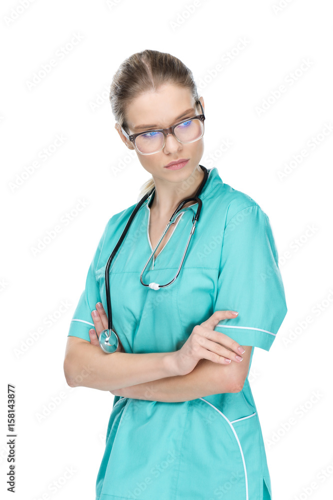 young doctor with stethoscope standing with arms crossed isolated on white