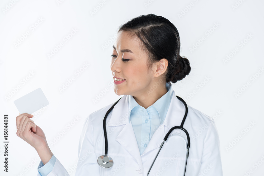 portrait of doctor looking at blank card in hand isolated on white portrait of doctor looking at blank card in hand isolated on white
