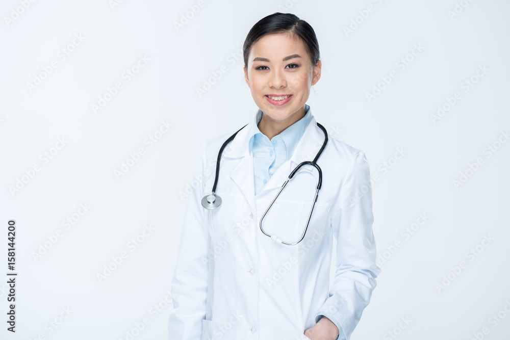 portrait of smiling doctor in white coat looking at camera isolated on white portrait of smiling doctor in white coat looking at camera isolated on white