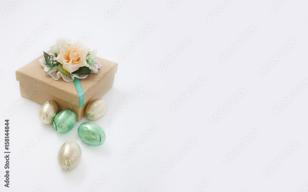 Box with flowers of roses and sweets in foil on a white background Box with flowers of roses and sweets in foil on a white background