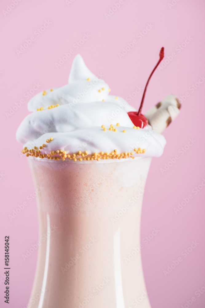 close up view of milkshake with cream and cherry on top in glass close up view of milkshake with cream and cherry on top in glass