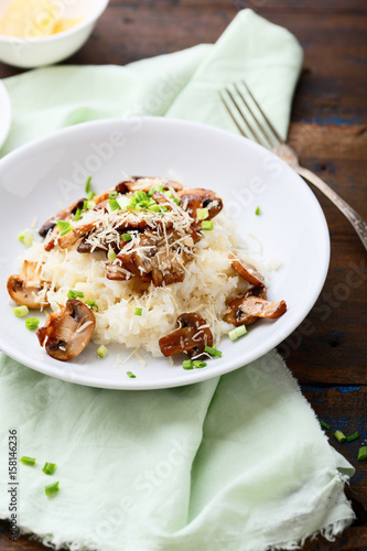 Tasty Risotto with mushrooms on white plate