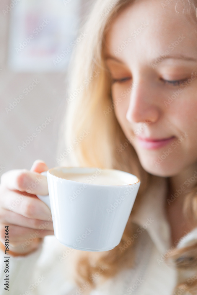 Coffee. Beautiful young woman holding in hand a cup of coffee Coffee. Beautiful young woman holding in hand a cup of coffee