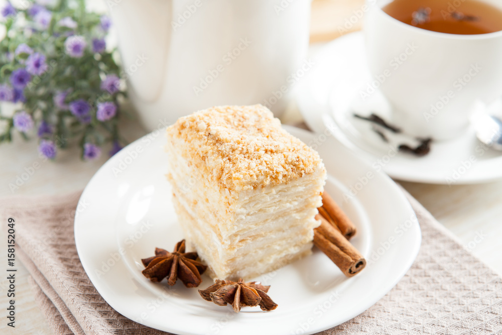Cake Napoleon close-up, cinnamon and anise with a cup of tea Cake Napoleon close-up, cinnamon and anise with a cup of tea