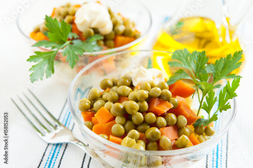 Vegetarian salad with canned peas and boiled vegetables close-up
