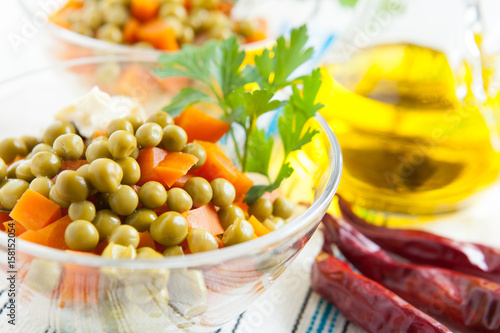 Salad with canned green peas and boiled carrots
